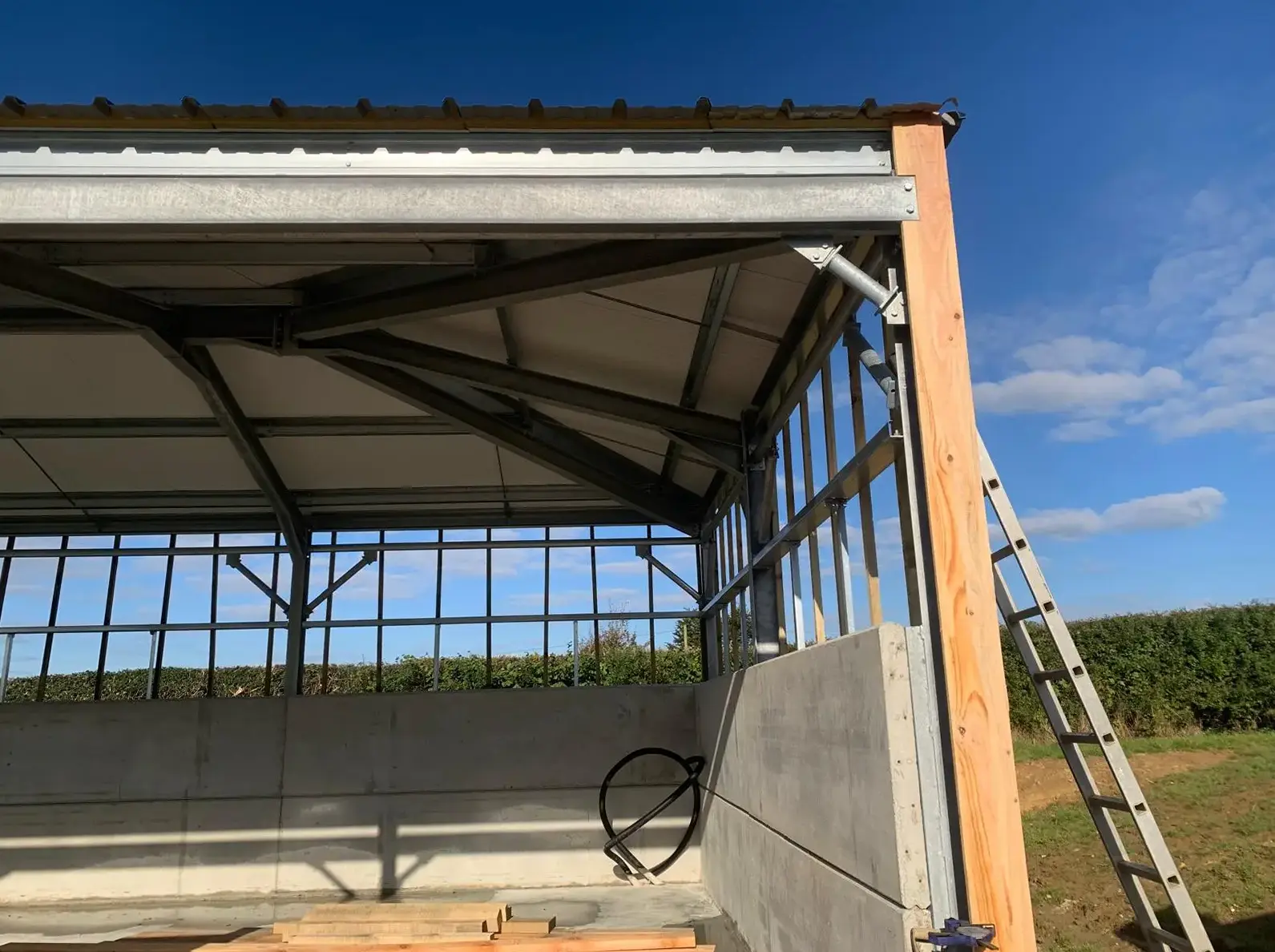 Bespoke barn construction showing slate-effect roof and larch cladding