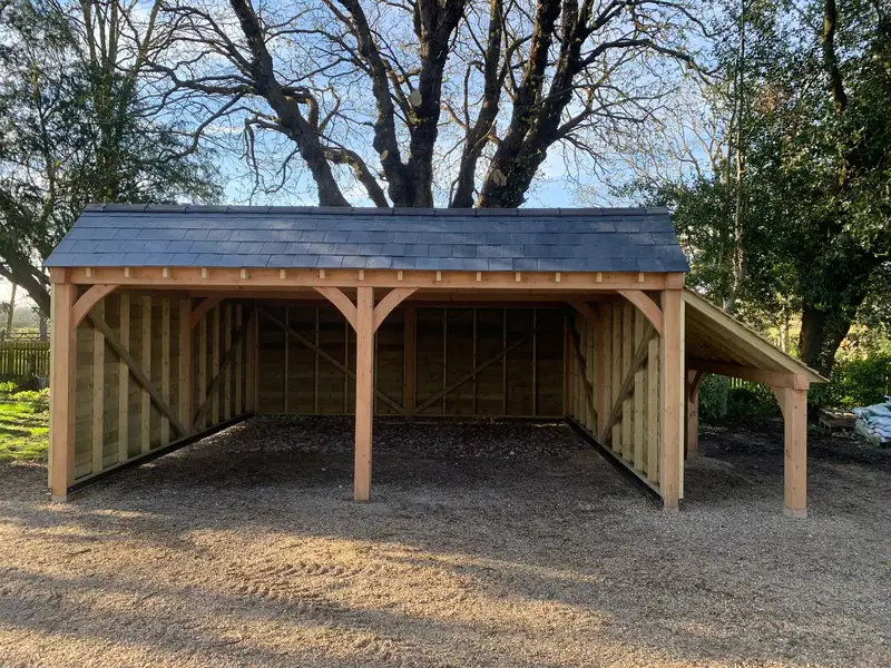 Oak frame open-fronted garage with slate roof