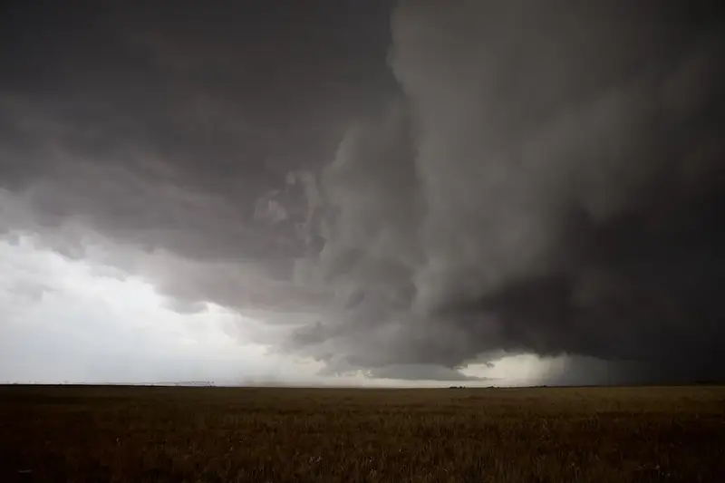Dark storm clouds over rural farmland